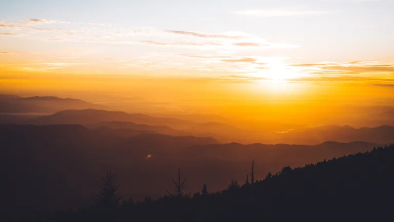 The wonderful news of the coming Kingdom of God is the heart and core of Jesus Christ’s message for humanity. Jesus will return to earth and establish this Kingdom. Sun rays shining over hills.