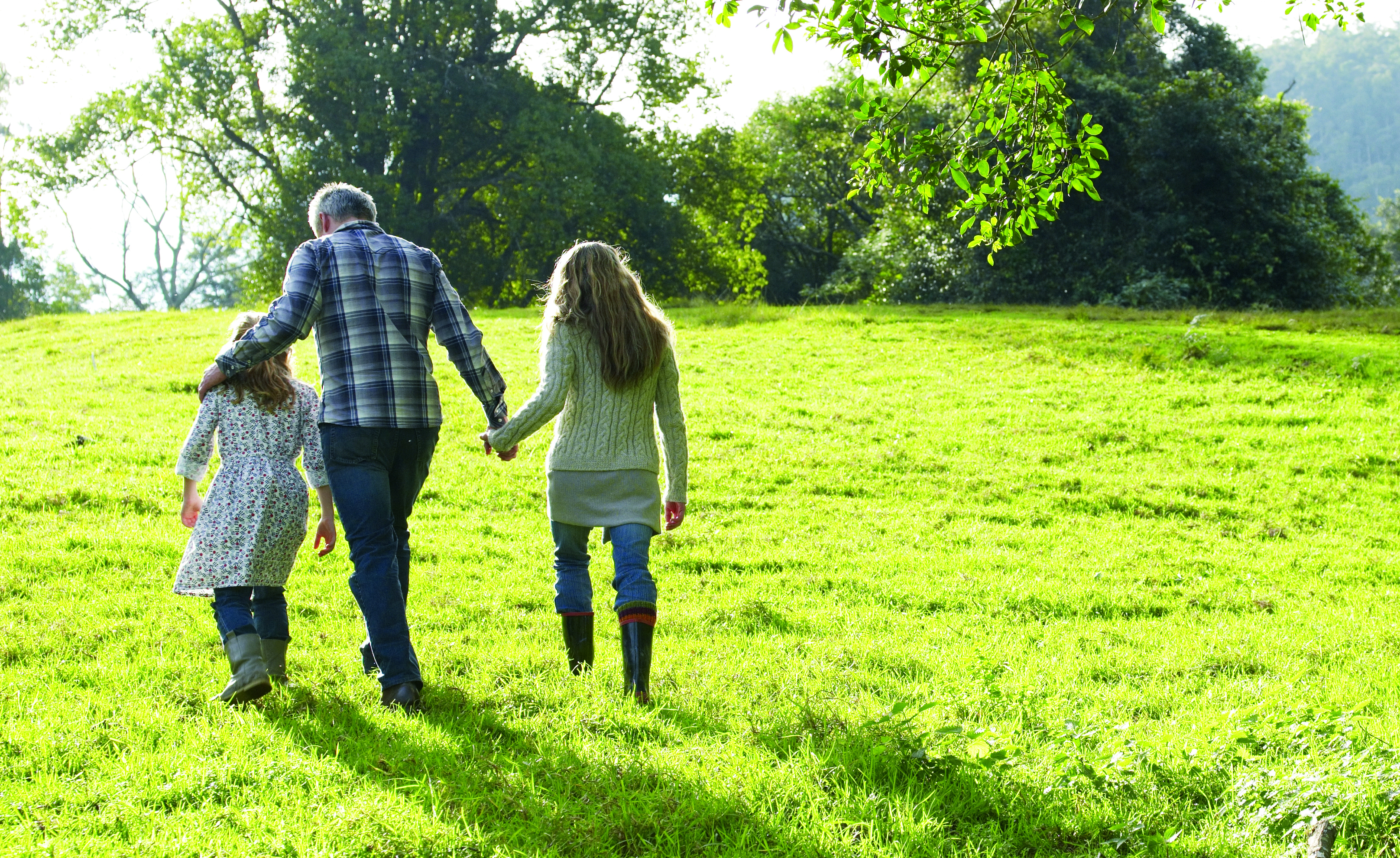 A family walking in a field.